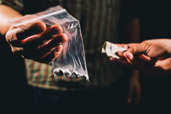 Drug dealer taking money in exchange for drugs, committing a federal drug crime