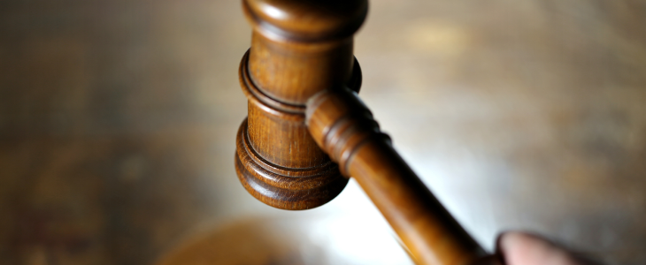 Judge slamming a mallet on a gavel due to a federal conviction