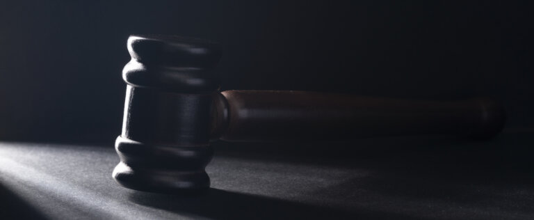 There is a gavel on the black table.