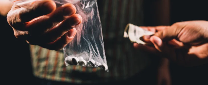 Man handing money for drugs